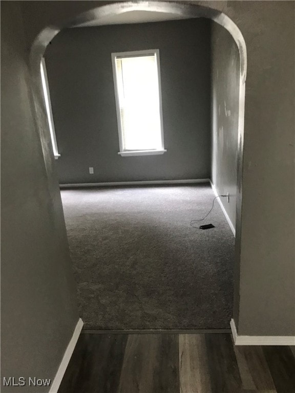 empty room with dark hardwood / wood-style flooring