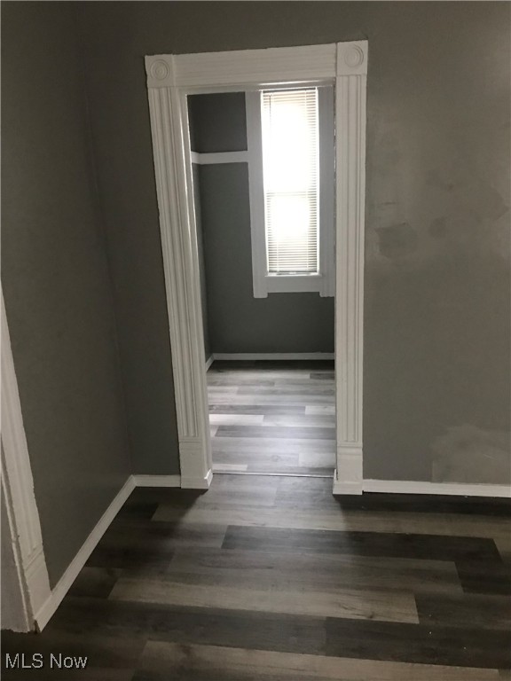 corridor with hardwood / wood-style flooring