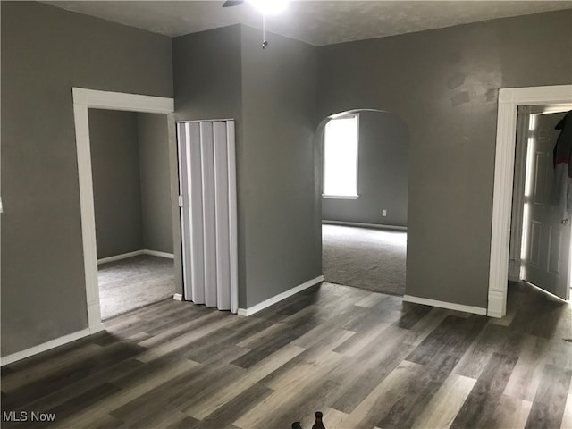 spare room featuring ceiling fan and dark wood-type flooring