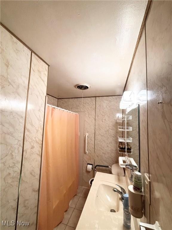 bathroom with tile patterned floors, vanity, and a shower with shower curtain