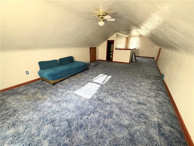 additional living space featuring ceiling fan, dark carpet, and vaulted ceiling