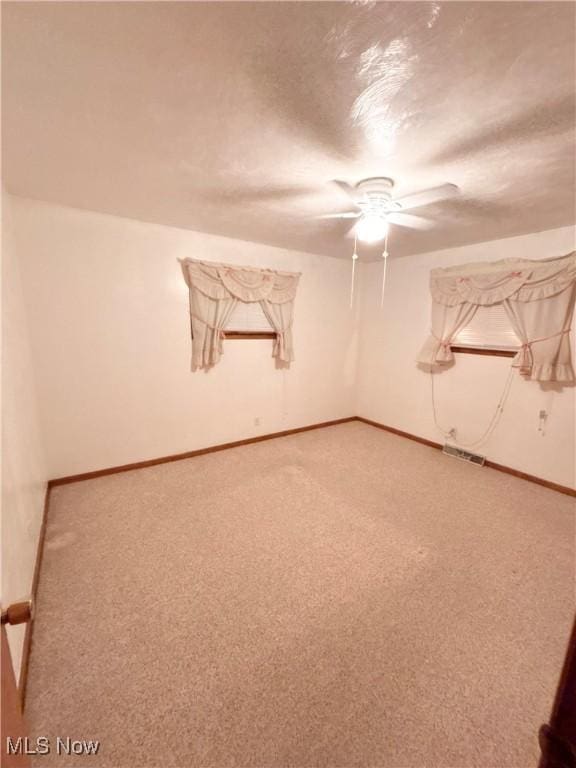 unfurnished room featuring ceiling fan and carpet