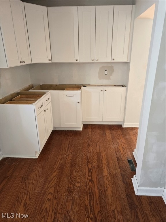 kitchen with white cabinetry and dark hardwood / wood-style floors