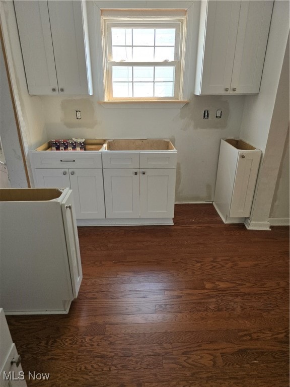 kitchen with white cabinets and dark wood-type flooring