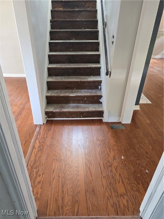 stairway featuring hardwood / wood-style floors