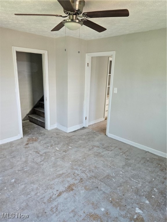 spare room with ceiling fan and a textured ceiling