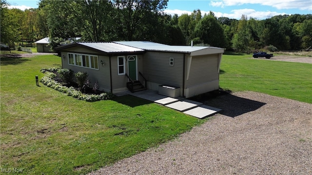 rear view of property featuring a lawn