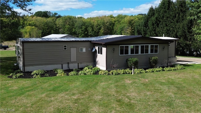 back of house with a lawn