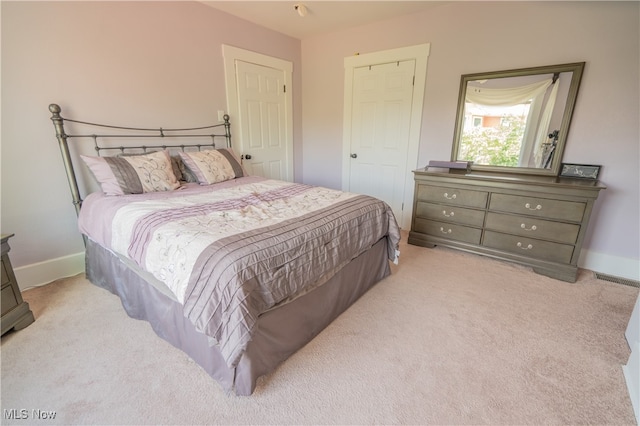 bedroom featuring light colored carpet