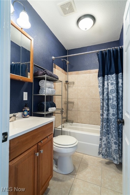 full bathroom with a textured ceiling, tile patterned floors, shower / bath combo with shower curtain, vanity, and toilet