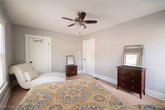 carpeted bedroom with ceiling fan and a closet