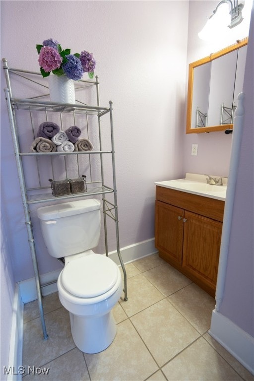 bathroom featuring tile patterned floors, vanity, and toilet