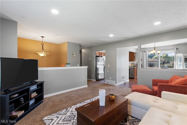 living room featuring a notable chandelier and carpet