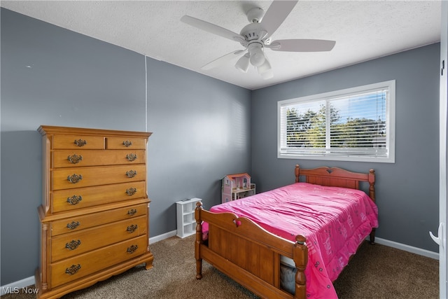 carpeted bedroom featuring ceiling fan and a textured ceiling