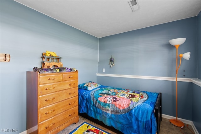 bedroom with dark tile patterned floors