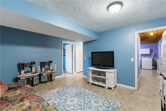 tiled living room with a textured ceiling and washer / dryer