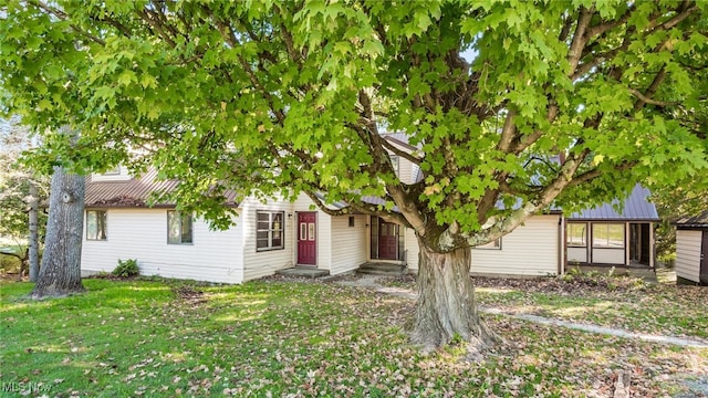 obstructed view of property with a front yard