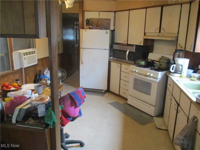 kitchen featuring cooling unit, white appliances, and sink