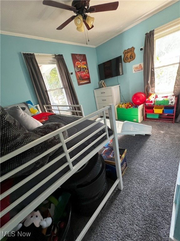 bedroom with carpet flooring, ornamental molding, and ceiling fan