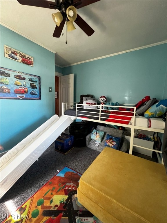 bedroom featuring ornamental molding, ceiling fan, and carpet flooring