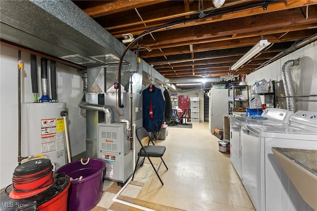 basement with water heater, heating unit, and washer and dryer