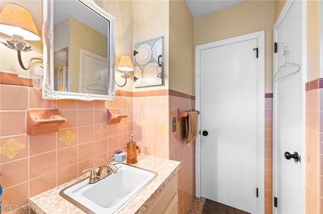 bathroom featuring vanity and tile walls