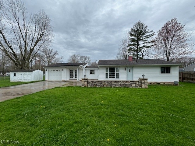 view of front of property with a front yard and a garage