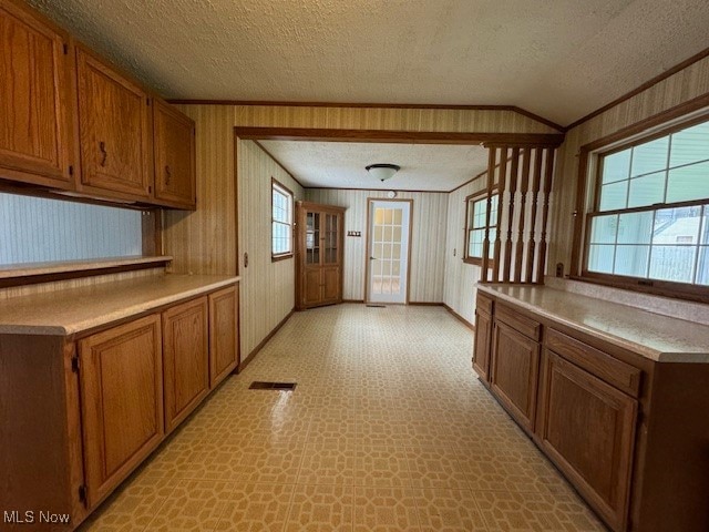 kitchen with a textured ceiling and ornamental molding