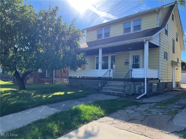 view of front of house with a front lawn and covered porch