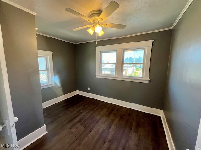 unfurnished room featuring ceiling fan, dark hardwood / wood-style floors, crown molding, and a wealth of natural light