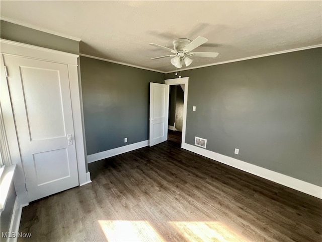 unfurnished bedroom with ornamental molding, ceiling fan, and dark hardwood / wood-style floors