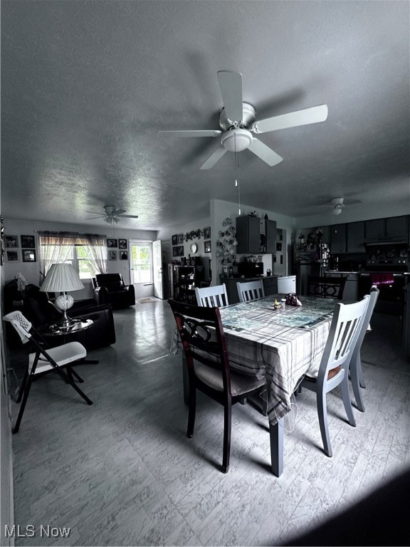 dining area featuring a textured ceiling and ceiling fan