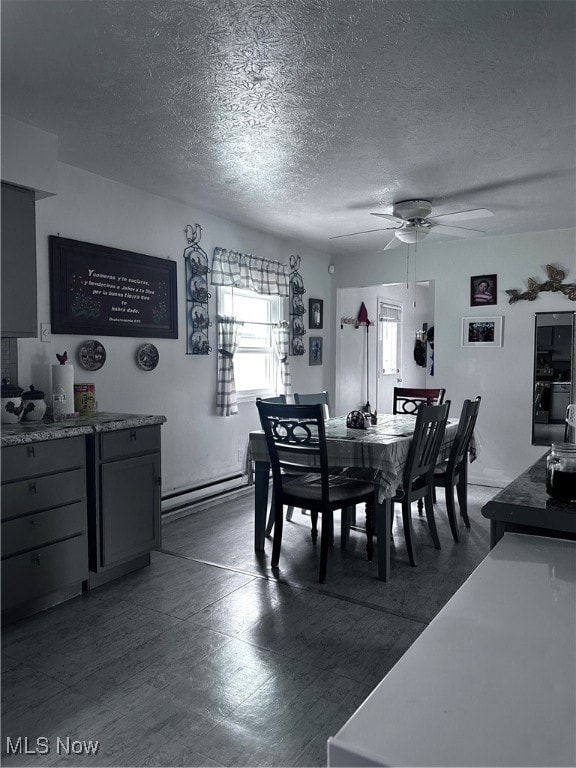 dining area featuring a textured ceiling and ceiling fan