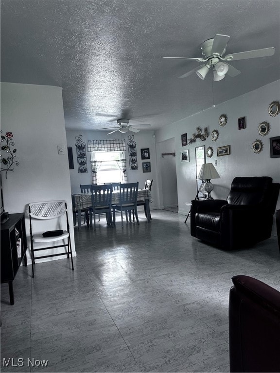 dining area with a textured ceiling and ceiling fan