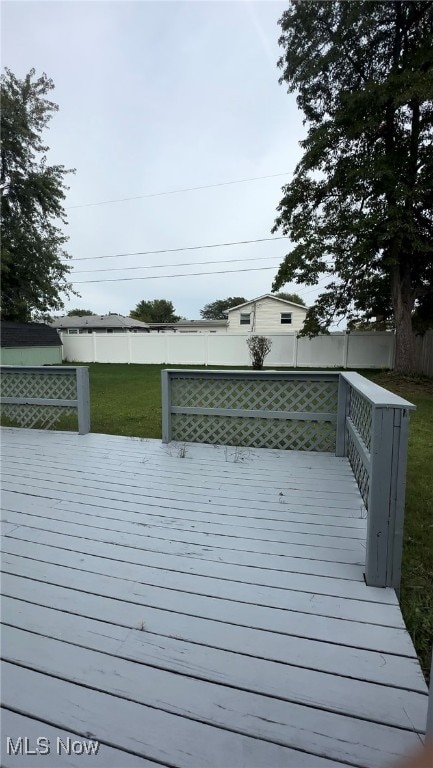 wooden terrace featuring a yard