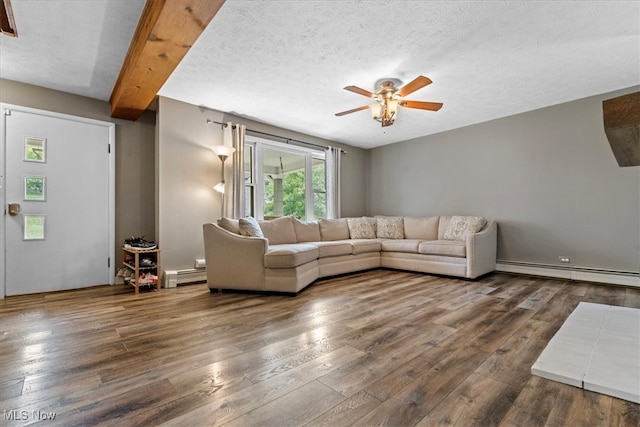 unfurnished living room featuring a textured ceiling, beam ceiling, dark wood-type flooring, and a baseboard heating unit