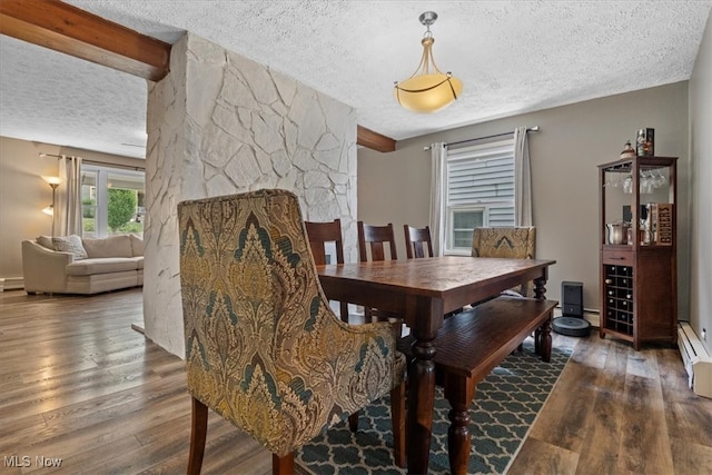 dining room featuring a textured ceiling, hardwood / wood-style floors, beamed ceiling, and a baseboard radiator