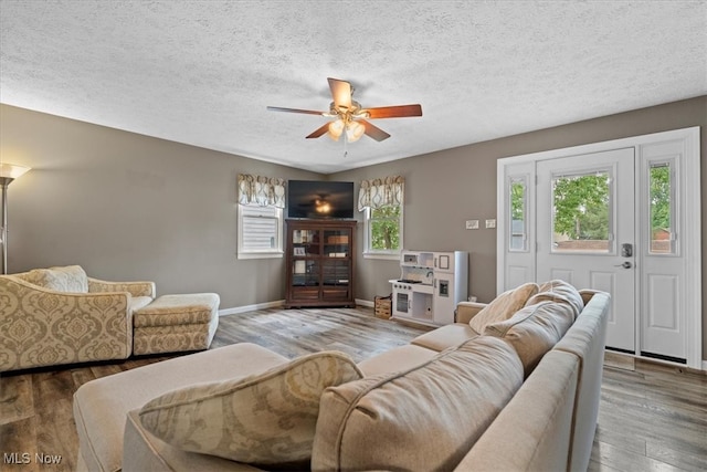 living room featuring a textured ceiling, hardwood / wood-style floors, ceiling fan, and plenty of natural light