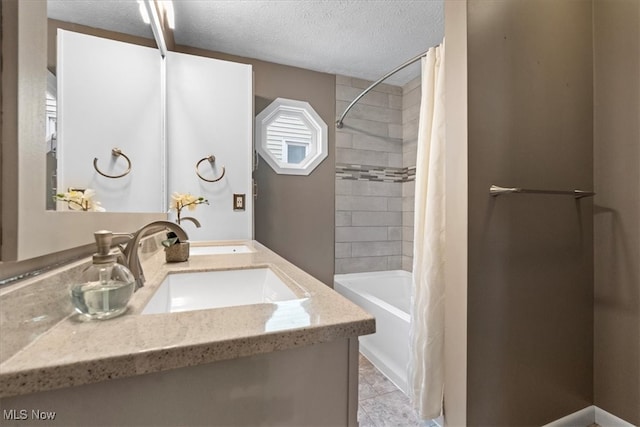 bathroom with shower / bath combo with shower curtain, tile patterned floors, a textured ceiling, and vanity