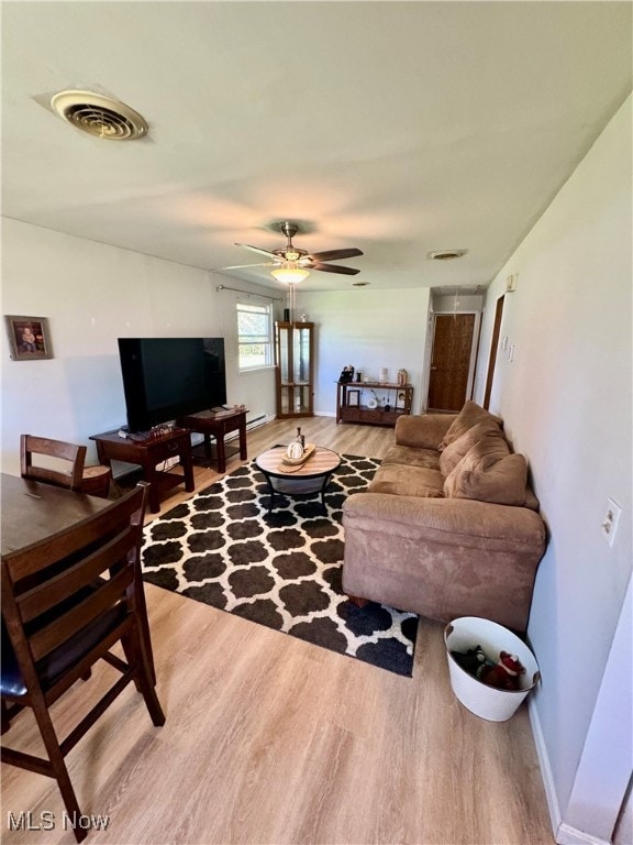 living room with hardwood / wood-style floors and ceiling fan