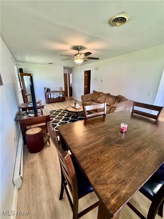 dining space featuring ceiling fan and hardwood / wood-style floors