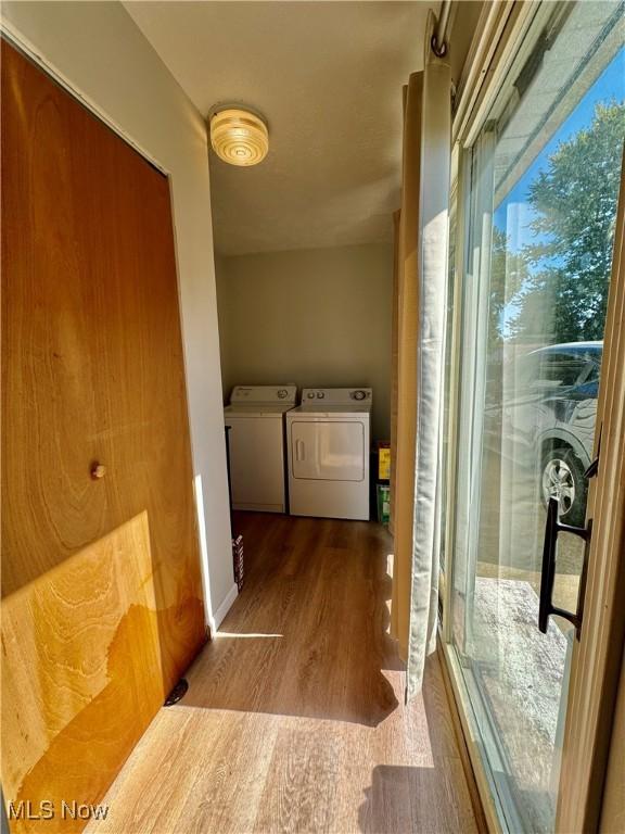 corridor featuring hardwood / wood-style flooring and washer and clothes dryer