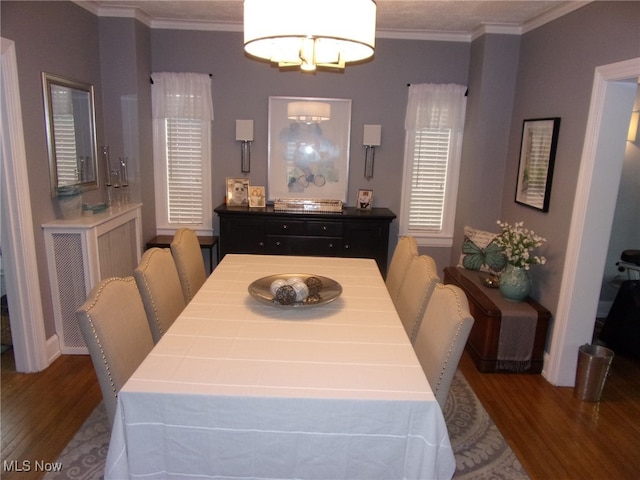 dining space featuring hardwood / wood-style flooring and crown molding