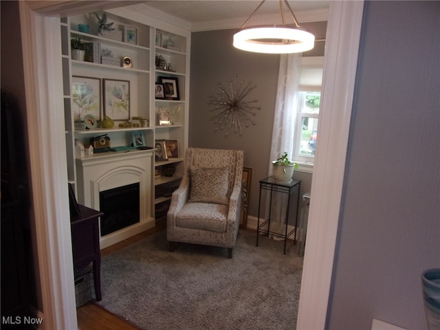 sitting room featuring carpet floors and crown molding