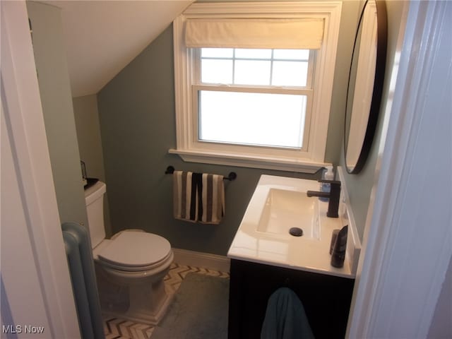 bathroom featuring vaulted ceiling, vanity, and toilet