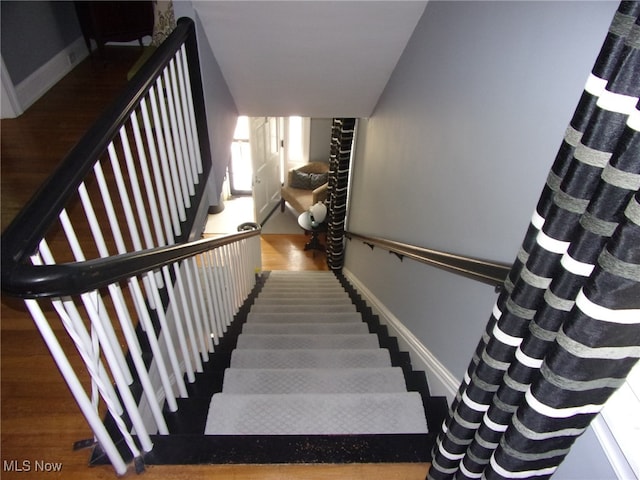 staircase featuring hardwood / wood-style floors