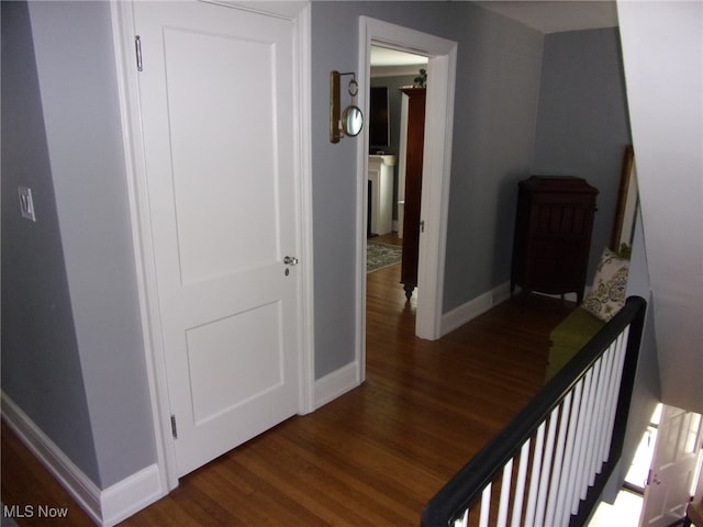 corridor with dark wood-type flooring