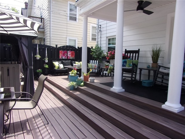 wooden terrace featuring ceiling fan