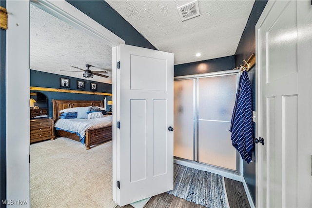 bedroom with a textured ceiling and light hardwood / wood-style floors