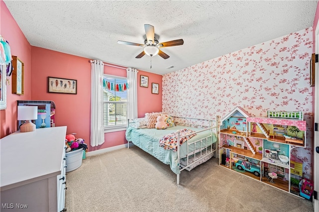 bedroom featuring ceiling fan, carpet flooring, and a textured ceiling